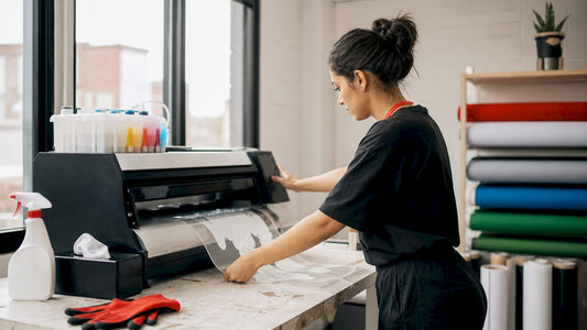 Small business owner operating DTF printer in studio