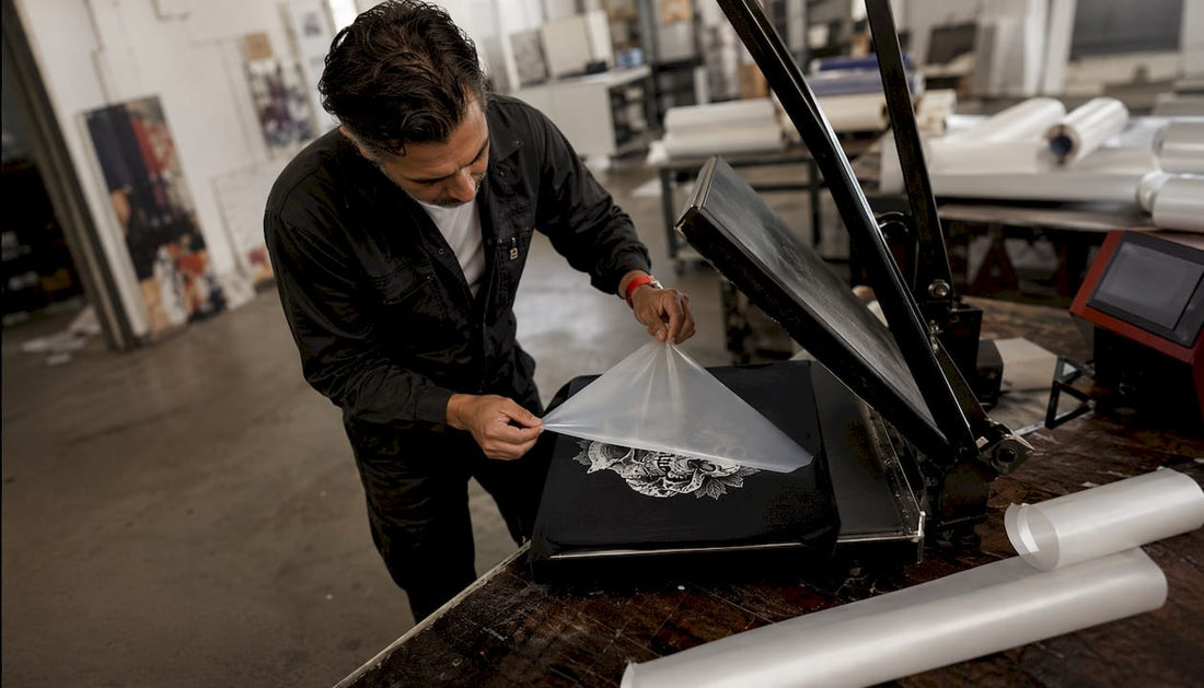 Technician peeling direct to film transfer with heat press