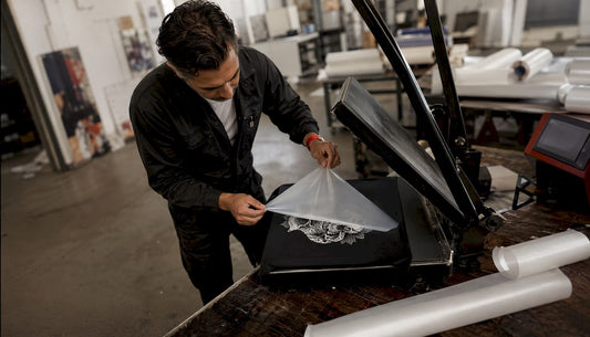 Technician peeling direct to film transfer with heat press