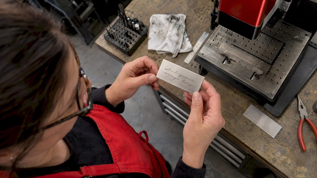 Shop owner checking a handwritten engraving test