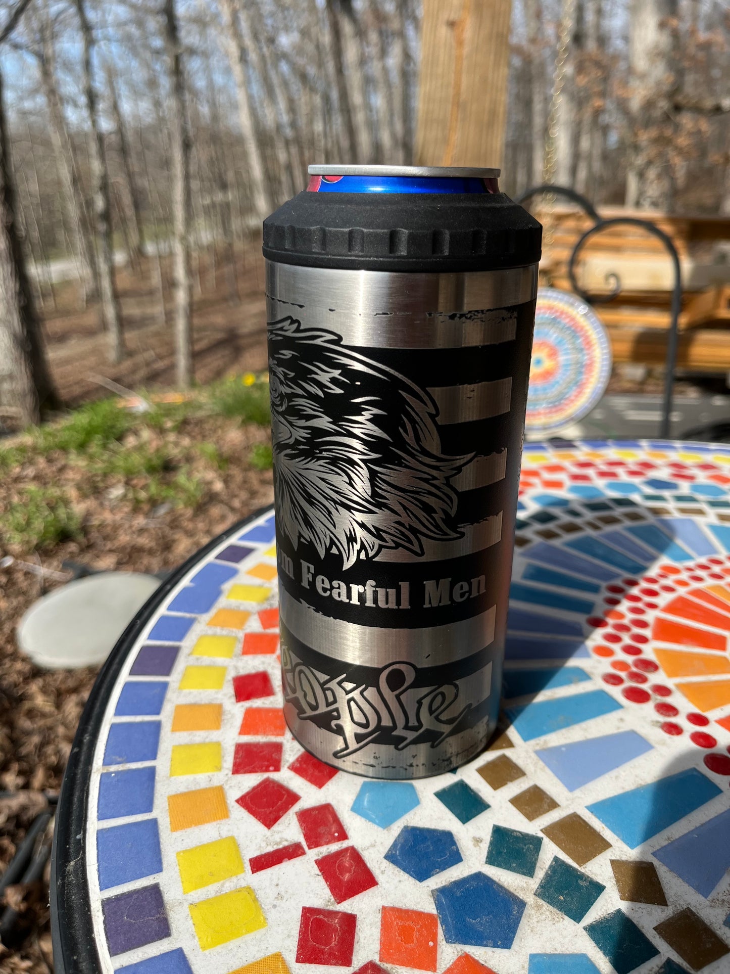 Metal tumbler with a logo on a mosaic table