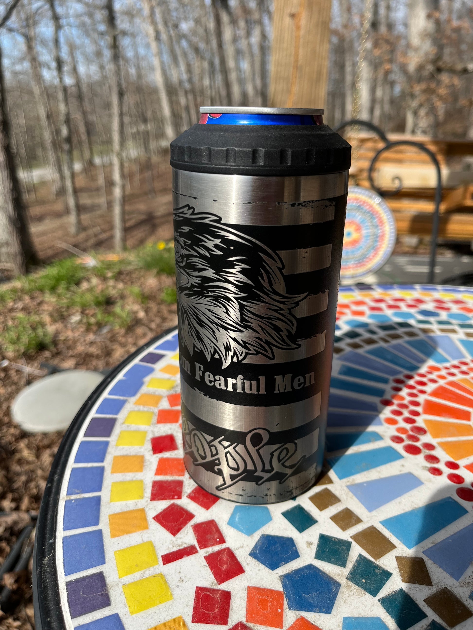 Metal tumbler with a logo on a mosaic table