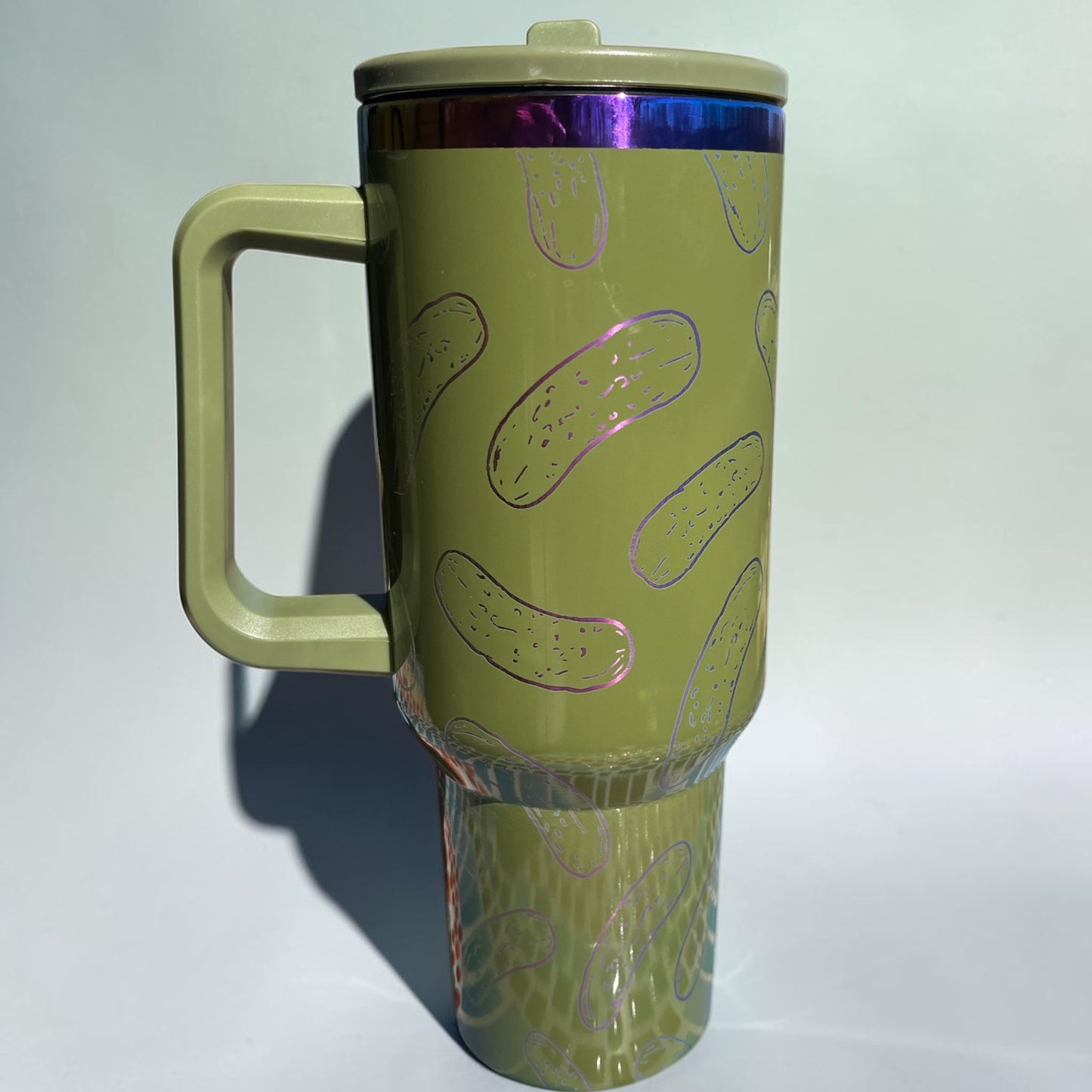 Green tumbler with pickle design on a white background