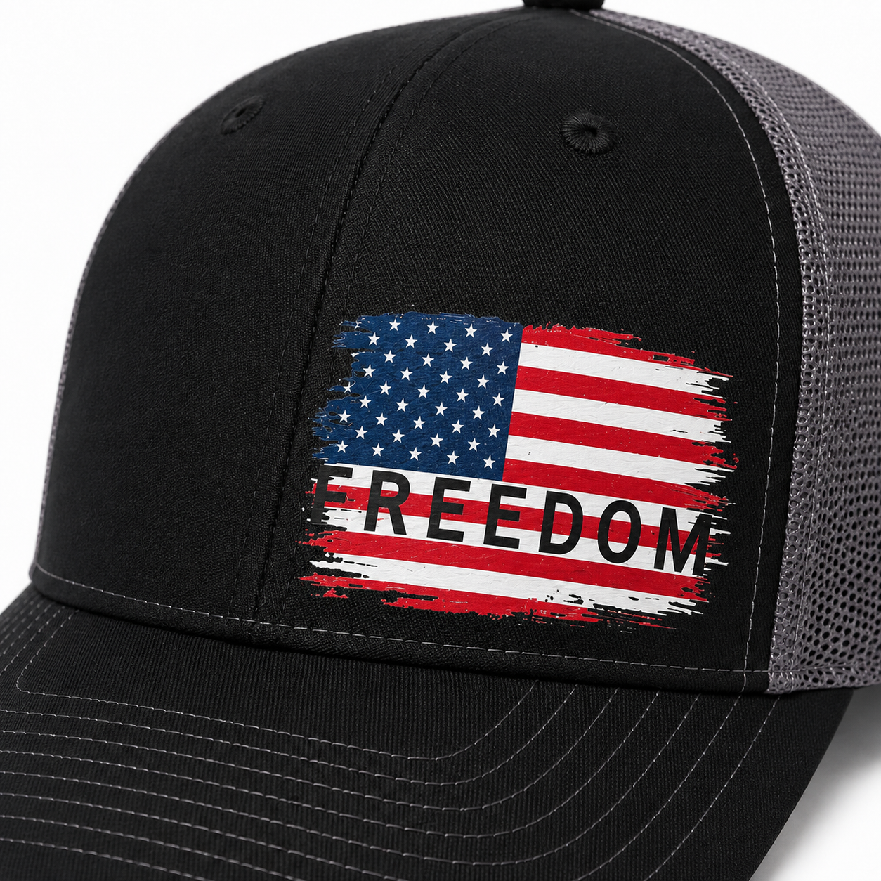Black trucker cap with a distressed American flag graphic on the front panel and the word 'FREEDOM' printed across it, shown on a white background.